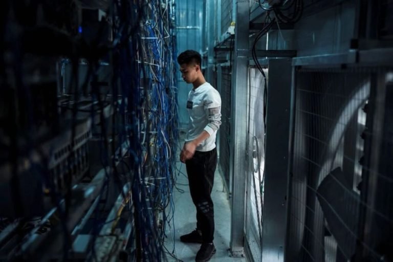 a-worker-in-a-cryptocurrency-mining-farm-in-dujiangyan-in-chinas-southwestern-sichuan-province