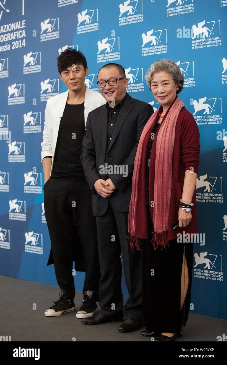 Director Wang Xiaoshuai (R) poses with cast members Qin Hao (L) and Lu Zhong during the red carpet for the movie ‘Chuangru zhe’ (Red amnesia) at the 71st Venice Film Festival September 4 2014.