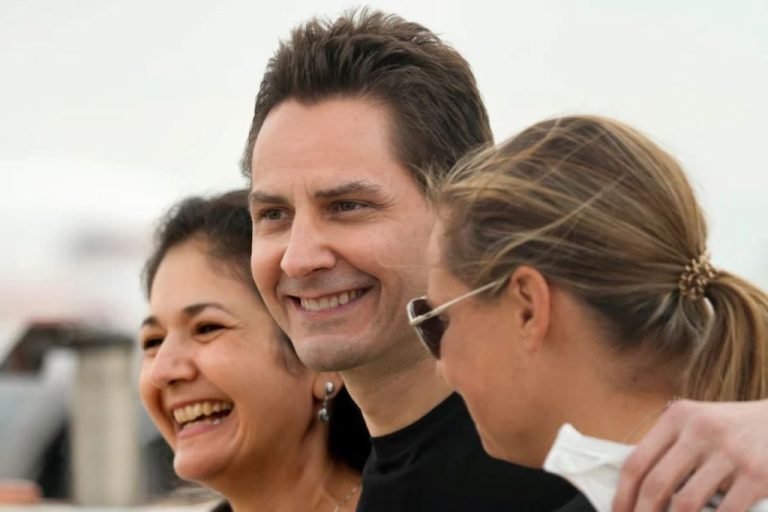 michael-kovrig-embraces-his-wife-vina-nadjibulla-left-and-sister-ariana-botha-on-september-25