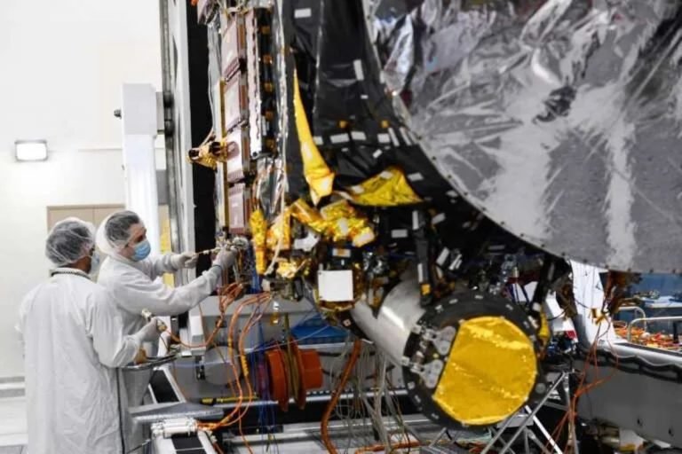 Workers prepare the Psyche spacecraft inside a clean room at NASA’s Jet Propulsion Laboratory (JPL) in Pasadena, California